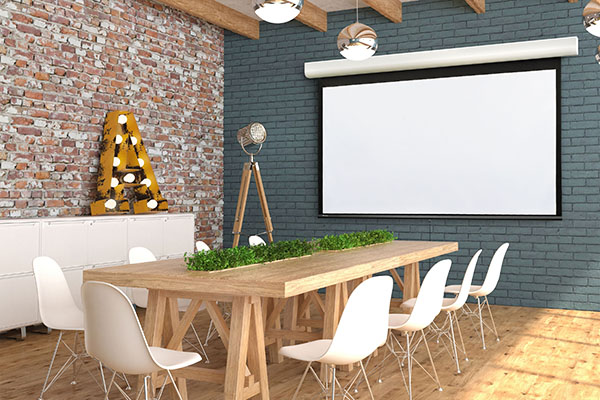 The Acumen M manual projector screen in a stylish multipurpose room